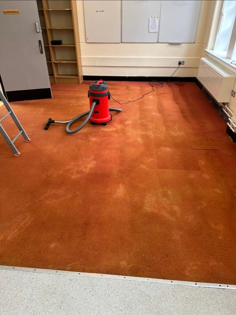 Professional carpet cleaning with industrial vacuum on an orange classroom carpet in a Dublin school or institutional building