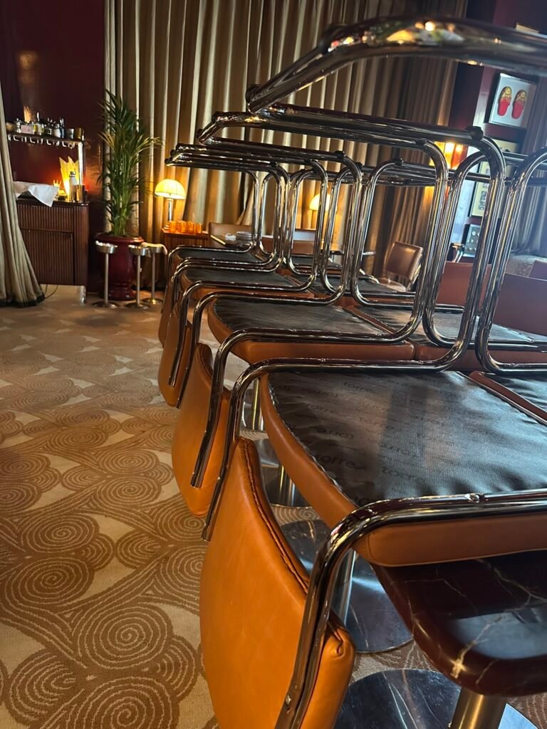 Restaurant chairs stacked on tables to clear carpet for deep cleaning service