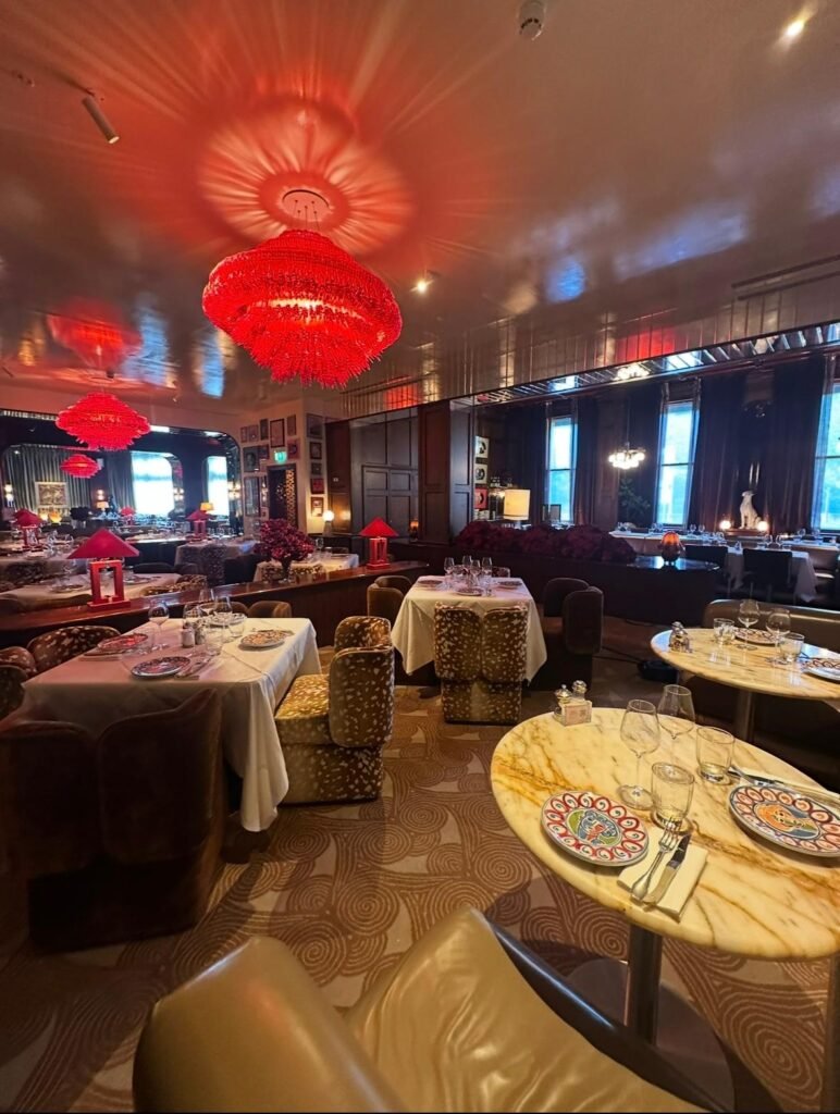 Deep cleaned patterned carpet in an upscale restaurant dining room with red chandeliers
